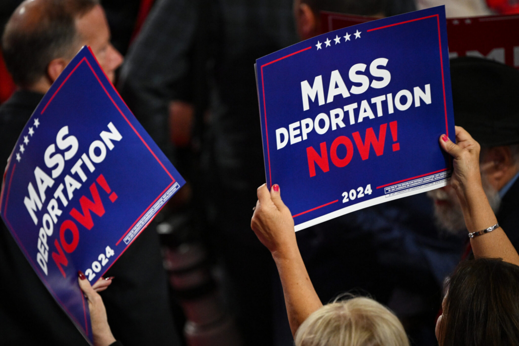 Une personne tient une pancarte sur laquelle on peut lire « Mass Deportation Now » (Expulsion massive immédiate) lors de la Convention nationale républicaine, le 17 juillet 2024 à Milwaukee, dans le Wisconsin. (Photo de Leon Neal/Getty Images)